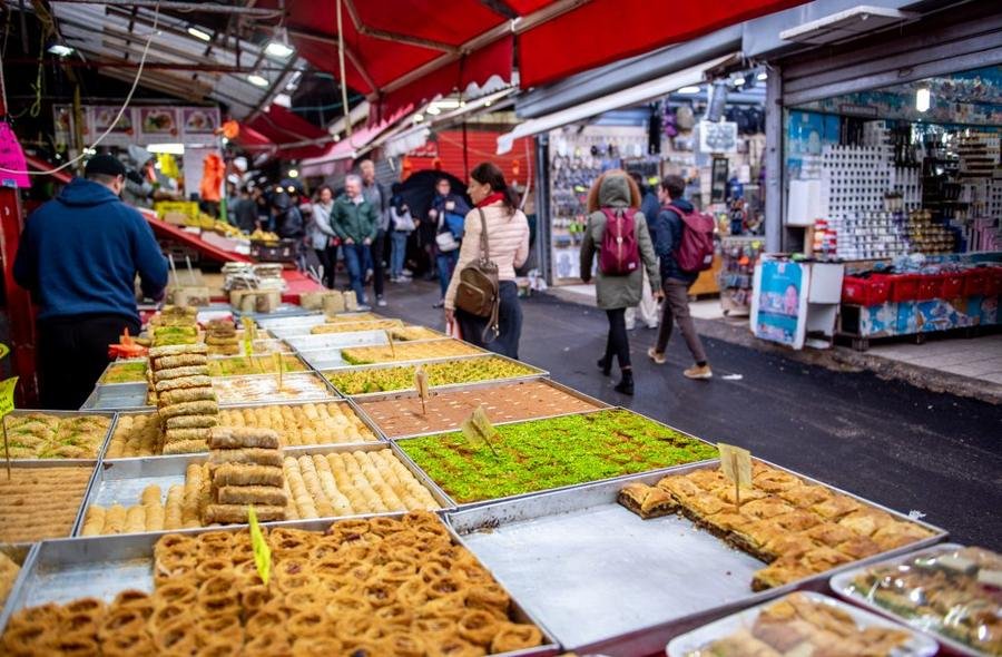 Sweets and pastry stalls at Carmel Market, moments from Shefer 19