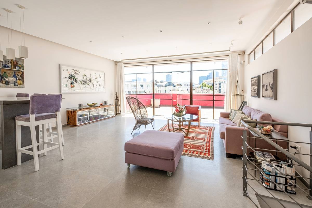 Open living and entertaining space on Floor 4 of the Shefer 19 duplex penthouse, opening onto the upper terrace